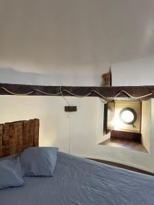 a bedroom with a bed with a round window at Moinho da Boavista in Serra do Bouro