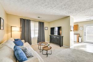a living room with a couch and a tv at Family Home with Ping-Pong and Fire Pit in Lexington in Lexington