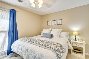 a bedroom with a bed with a blue curtain at Family Home with Ping-Pong and Fire Pit in Lexington in Lexington