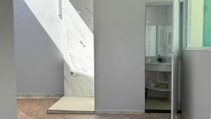 une salle de bain avec un lavabo et un miroir dans l'établissement Casa Area Gourmet, Wi-fi,Barbecue,Petfriendly, à Peruíbe 22 autres photos