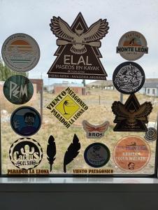 a window with a bunch of badges on it at Elal kayak in Comandante Luis Piedra Buena +5 photos