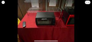 a tv sitting on a table with a red table cloth at Tarawa drive in Cincinnati