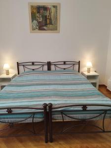 a bed in a bedroom with two lamps on tables at Rental room pilika4 in Athens