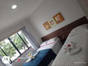 a bedroom with a bed and a large window at Pousada Village in Barreirinhas