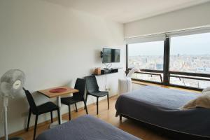 a bedroom with a bed and a table and chairs at Siempre bien En el Centro y Cerca del Obelisco 1 a 5 pas in Buenos Aires