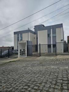 a building with a fence in front of it at Nosso lar in Campina Grande