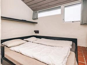 a bed in a room with two pillows on it at 6 person holiday home in Brovst in Brovst