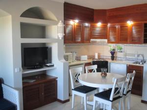 eine Küche mit einem weißen Tisch und Stühlen in einem Zimmer in der Unterkunft Bellavista Mar in Albufeira