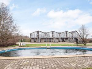 a house with a pool in front of it at 2 person holiday home in Højer in Højer