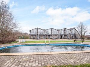 a house with a pool in front of it at 16 person holiday home in Højer in Højer