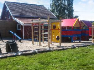 a playground in front of a building at 4 person holiday home in Risør in Risør