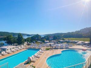 an aerial view of the pool at a resort at 4 person holiday home in Risør in Risør +4 photos