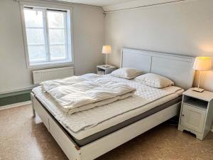 a bedroom with a large bed with two night stands at 4 star holiday home in åMMEBERG in Åmmeberg
