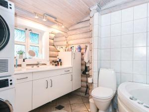 a bathroom with a toilet sink and a refrigerator at 4 star holiday home in Fårvang in Fårvang +24 photos