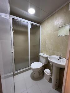 a bathroom with a shower and a toilet and a sink at Sierra Serena Habitaciones in Santa Marta +19 photos