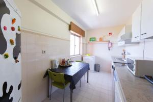 a kitchen with a table and chairs in a room at Enjoy the Ria Formosa Estuary in Faro