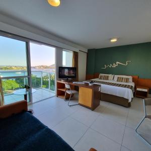 Ένα ή περισσότερα κρεβάτια σε δωμάτιο στο Flat charmoso na ilha de Vitória Praia do Canto