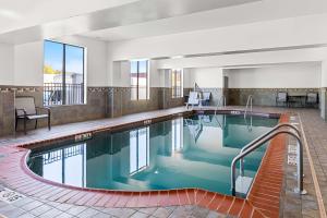 a large pool with blue water in a hotel room at Best Western St. Louis Airport North Hotel & Suites in Hazelwood