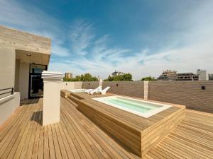 a deck with a swimming pool on top of a building at Anywhere Palermo Soho in Buenos Aires