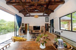 a living room with a couch and a table at Lavita villa Resort in Sóc Sơn
