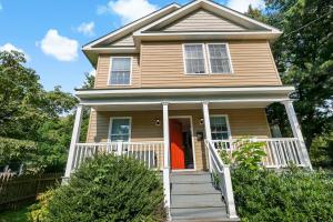 a brown house with a red door and stairs at Havenly Homes DMV in Arlington +146 photos