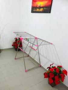 a metal shelf with red flowers in a room at Khongaha Villa Holiday Home #AC in Mirissa