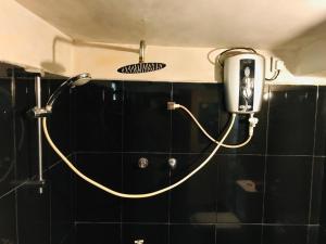 a shower head with a hose attached to a wall at Khongaha Villa Holiday Home #AC in Mirissa
