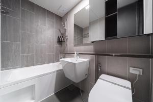 a bathroom with a white toilet and a sink at Le Collective Busan Gijang in Busan +56 photos