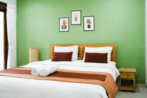 a bedroom with a large bed with green walls at Massive 3 bedroom villa in heart of Seminyak in Seminyak