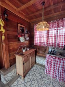 una cocina con una isla en el medio de una habitación en Recanto sol maior - Chalé Jasmin, en Sapucaí-Mirim 22 fotos más
