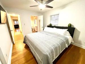 a bedroom with a bed and a ceiling fan at Large Private Ranch - Master Bedroom Suite with King Bed and private Bathroom - Fenced Yard - Pets & Kids Welcome - Pool Table in Columbus