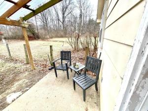 two chairs and a table on a patio at Large Private Ranch - Master Bedroom Suite with King Bed and private Bathroom - Fenced Yard - Pets & Kids Welcome - Pool Table in Columbus