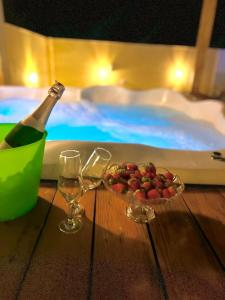 a bottle of champagne and a bowl of fruit next to a swimming pool at Casa Diamantina in Ibicoara +53 photos