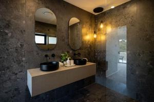 a bathroom with two sinks and two mirrors at Luxurious Waterfront Retreat in Oatley in Oatley +48 photos