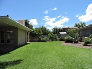 a yard of a house with green grass at The Hamlet House in Prince Alfreds Hamlet