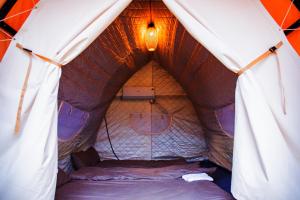 a room with a bed in a tent at Mây home Trạm Tấu lều khách sạn in Ya Ló +29 photos