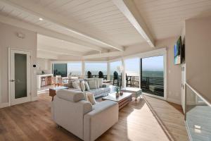 a living room with a couch and a table at Oceanfront Paradise on Neptune in Encinitas