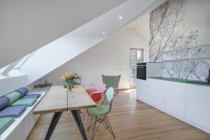 a dining room with a table and chairs at Wohnen in der Villa Kunterbunt nahe der 5-Seen-Landschaft in Puchheim
