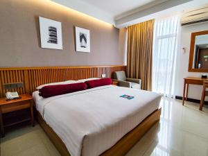 Postel nebo postele na pokoji v ubytování Ivory Hotel Bandung + 25 fotografií