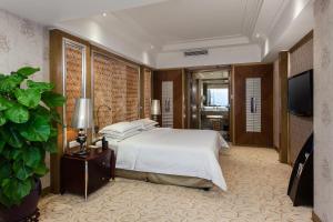 Voodi või voodid majutusasutuse Guangzhou Good International Hotel toas