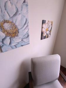 a room with a chair and a painting on the wall at La Palmera in Lima