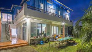 a house with a table in front of it at Jeju CountryFarmpension in Seogwipo