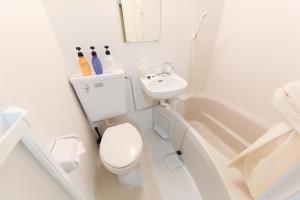 a white bathroom with a toilet and a sink at Osaka Condo walk to Shinsaibashi 8ppl 501&502 in Osaka +21 photos
