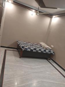 a bed in a corner of a room at Rock well in Prayagraj