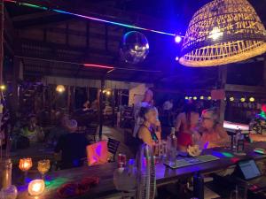 a group of people sitting at a bar at night at Easy Tiger - M'Pai Bay Beach, Koh Rong Sanloem in Koh Rong Sanloem +46 photos