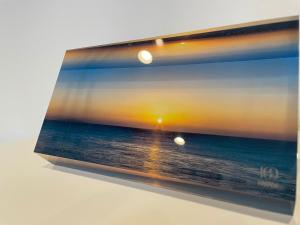 a picture of the ocean with a sunset at Port House Fukuoka in Fukuoka