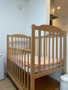 a wooden crib in a room at Port House Fukuoka in Fukuoka