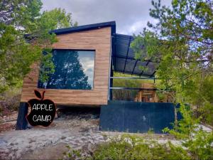 a small house with a large window in the middle at Cabaña 7 APPLE CAMP in San Antonio de las Alzanas