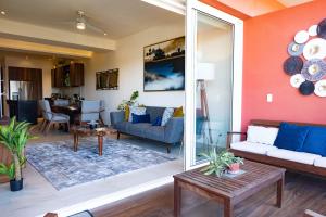 a living room with a couch and a table at Charming 2BR Condo with Private Terrace in Nuevo Vallarta-Pool-Panoramic Views! in Nuevo Vallarta 