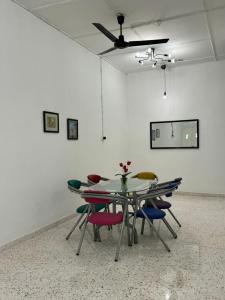 a table and chairs in a room with a ceiling at Yipstay Gopeng HomeTown in Gopeng